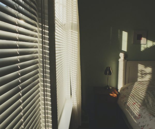 sunlight coming through the blinds in a bedroom